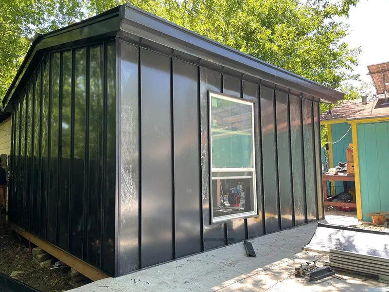 Black standing seam metal wall panels for Roof Inspection in Giddings