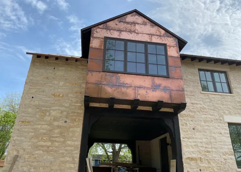Copper metal panel facade on a stone building for Skylight Installation in Giddings